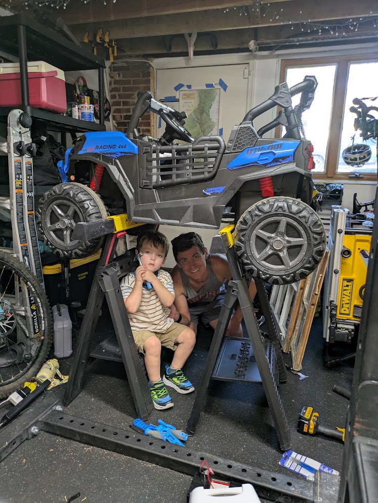 My son and me pretending to do some maintenance work on his toy electric car.